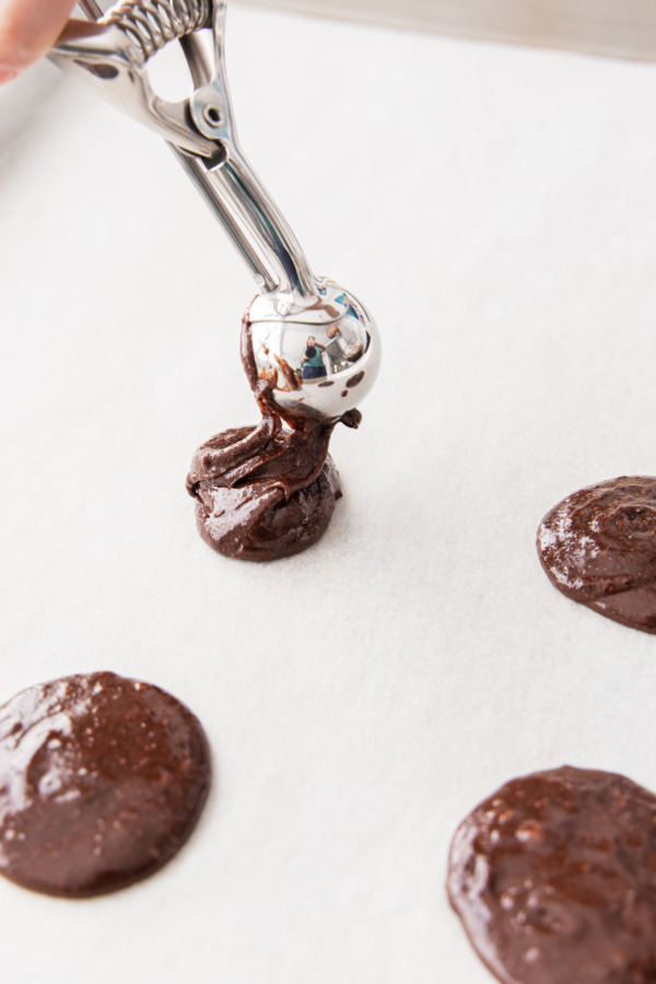 Twisting the cookie scoop to help form round cookies.