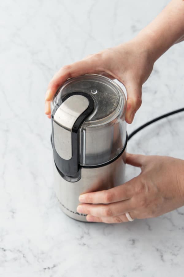 Grinding black sesame seeds in a coffee or spice grinder.