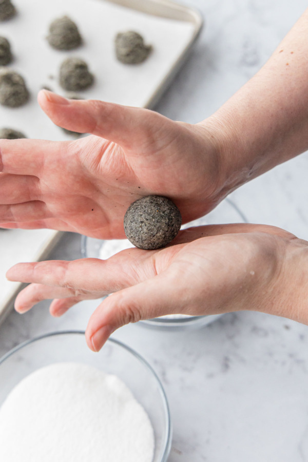 Rolling the dough between your palms to form a smooth ball.