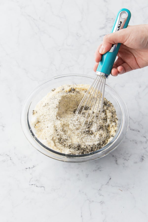 Whisking the almond and black sesame powders together until evenly distributed.