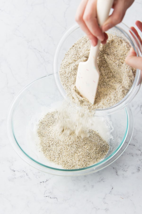 Adding dry ingredients to bowl with whipped egg whites.