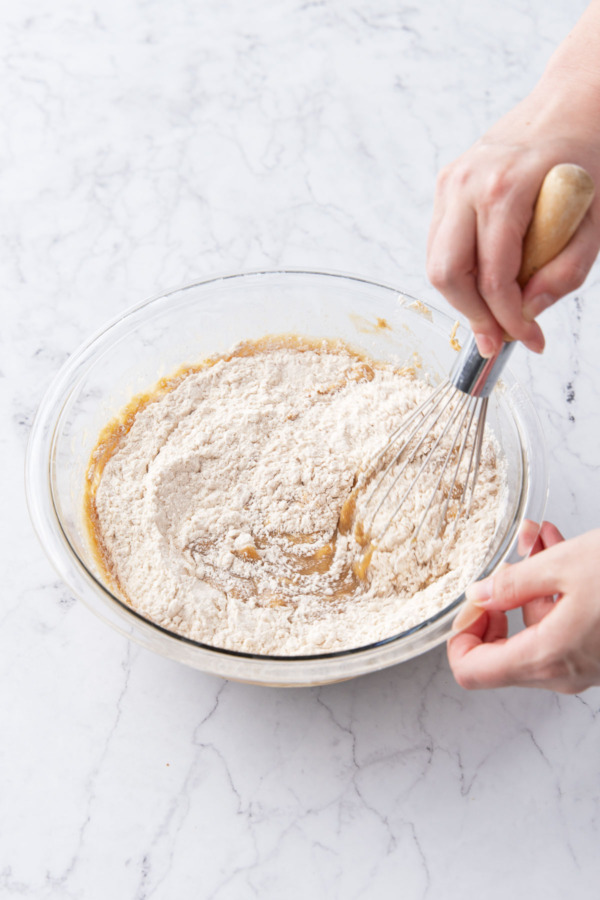 Adding dry flour ingredients and mixing with a wire whisk.